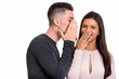 © Ranta Images - Happy couple smiling while man whispering to woman