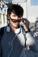 Portrait Of Cool Man With Sunglasses And Headphones In The City