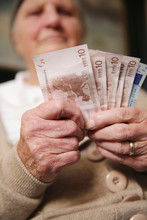 Senior Woman Holding Euro Notes
