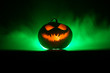 © zef art - Halloween pumpkin smile and scary eyes for party night. Close up view of scary Halloween pumpkin with eyes glowing inside at black background