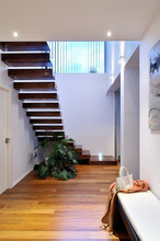 Contemporary House Hall With Wooden Stairs