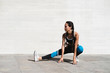 © Cavan Images - Full body of female athlete stretching legs