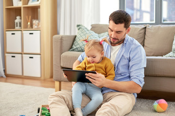 Canvas Print - family, fatherhood and technology concept - happy father and baby daughter with tablet pc computer at home