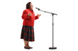 Elderly woman singing on a microphone and gesturing with hands