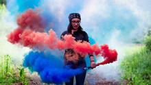 Young Girl With Glasses Posing With Colored Smoke