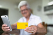 © Sergio - older woman at home with new technologies