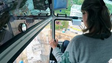 A Woman Is Sitting In The Cabin And Operating A Building Crane