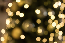 Christmas With Gold Bokeh Light Background. Xmas Abstract Blur And Glowing Decorations Outdoors.