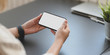 © bongkarn - Cropped shot of professional businesswoman holding horizontal blank screen smartphone