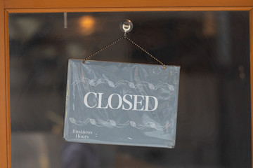 Wall Mural - sorry we are closed sign hanging outside a restaurant, store, office or other