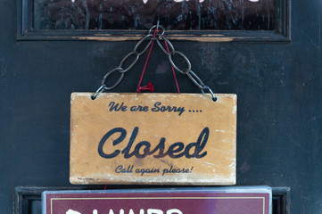 Wall Mural - sorry we are closed sign hanging outside a restaurant, store, office or other