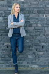 Wall Mural - Middle-aged fit woman wearing cool slim blue jeans