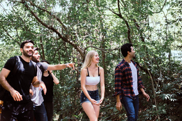 Group of traveler friends walking together at rain forest,Enjoying trekking concept