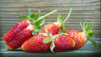 Strawberry berry on wooden table. Fresh berries for summer diet.