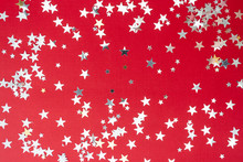Red Background With Silver Glitter Selective Focus. Christmas Texture Mockup.