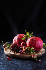 Canvas Print - Sweet red pomegranate with green leaves