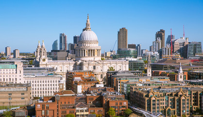 St. Paul's cathedral and City of London view including river Thames and Millennium bridge in early morning.