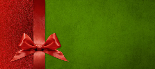 gift card wishes merry christmas background with red ribbon bow on green shiny vibrant color texture