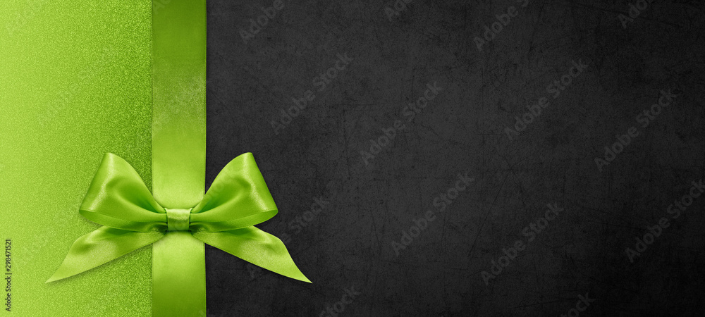 gift card wishes merry christmas background with green ribbon bow on black shiny vibrant color texture template with blank copy space - obrazy, fototapety, plakaty 