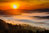 Fototapeta  - Misty sunrise in mountains