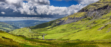 Panorama Of The Struggle Road At Kirkstone Pass Leading To Windermere Lake Ambleside With Red Screes Mountain On Right In Lake District England
