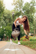 © Viktoriia - Plogging. Young girl volunteer running outdoors picking up litter smiling cheerful