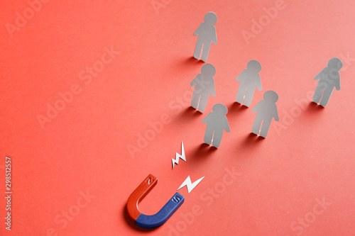 Cuadros en Lienzo Magnet attracting paper people on red background, space for text