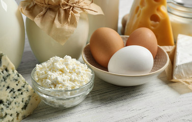 Different dairy products on white wooden table, closeup