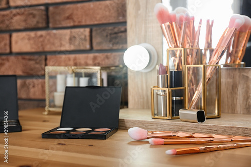 Fotografía Cosmetic and brushes on dressing table in makeup room