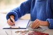 © New Africa - Woman counting money at wooden table, closeup