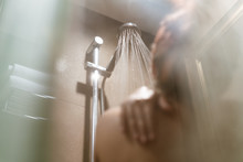 Young Diverse Woman Taking A Shower In The Bathroom And Getting Ready For Work - Millennial Girl Showering With Hot Steam Filling The Room - Lifestyle, Bathe And Hygiene Concept