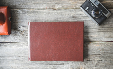 Old photo album lying on a wooden surface. Retro album.