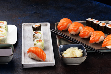 Wall Mural - close up of sashimi sushi set with chopsticks and soy - sushi roll with salmon and sushi roll with smoked eel