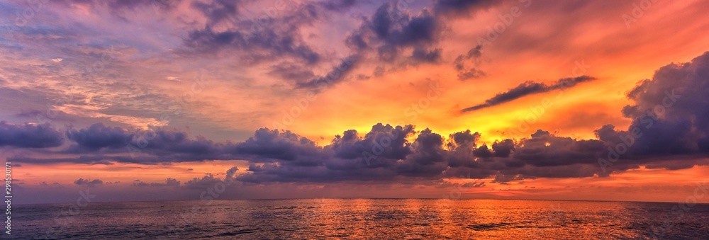 Phuket beach sunset, colorful cloudy twilight sky reflecting on the sand gazing at the Indian Ocean, Thailand, Asia. - obrazy, fototapety, plakaty 