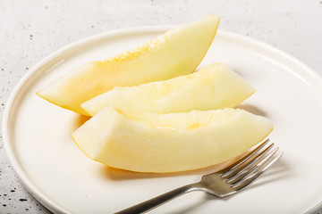 Wall Mural - Sweet yellow fresh melon on white concrete table