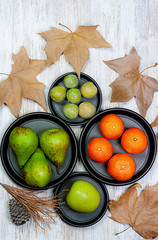 VARIETY OF AUTUMN FRUITS WITH TREE LEAVES ON WOODEN TABLE 2. AUTUMN SEASON FRUIT