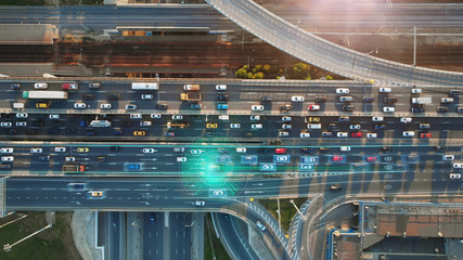 Wall Mural - Beautiful top view to autonomous cars self-driving on multi-level highway in Moscow. Picturesque aerial panorama of the road traffic in a big city on the evening.