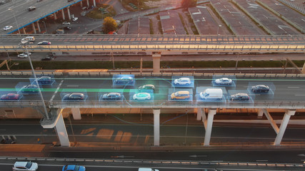 Wall Mural - Beautiful aerial presentation of self-driving cars concept on multi-level highway in Moscow. Picturesque aerial panorama of autonomous cars in the road traffic of big city on the evening.