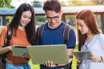 Wall Mural - Young Man and classmates, student hold laptop