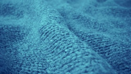 Wall Mural - Extreme detail view of sheep wool cloth texture in macro dolly shot. Flowing animal fiber material for handcraft knitting. Textile abstract background. Winter fashion clothing industry concept.