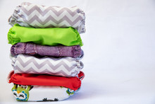 Pile Of Eco Friendly Cloth Nappies / Diapers On A White Background 