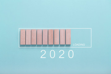 Loading new year 2020 concept , Showing loading bar with wood cube on bluebackground