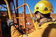 © Kings Access - Side view good safety practice of male miner wearing safety helmet protective gear walking up stair holding a hand rail with three point of contact while working on construction mine site, Sydney