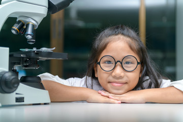 Wall Mural - happy little child smile and learning in school laboratory