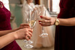 © Wedding photography - Wedding time. Bridesmaids clink glasses with champagne on bride with wedding dress background