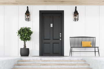 black front door of white house, tree and bench