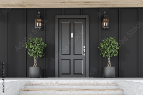 Fotografía Black front door of black house with trees
