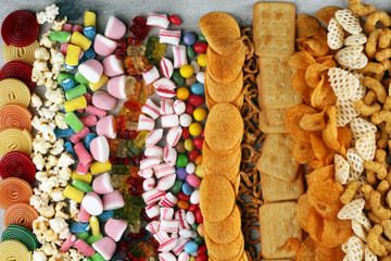 Wall Mural - Salty snacks. Pretzels, chips, crackers and candy sweets on table