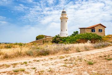 Canvas Print - Republic of Cyprus. Pathos. Lighthouse on the coast. Archaeological park. Paphos archaelogical site. Lighthouse on the shores of the Mediterranean Sea. Walks in Cyprus. House Near Lighthouse