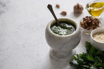 Wall Mural - Homemade parsley pesto sauce and ingredients. Vegan healthy food.